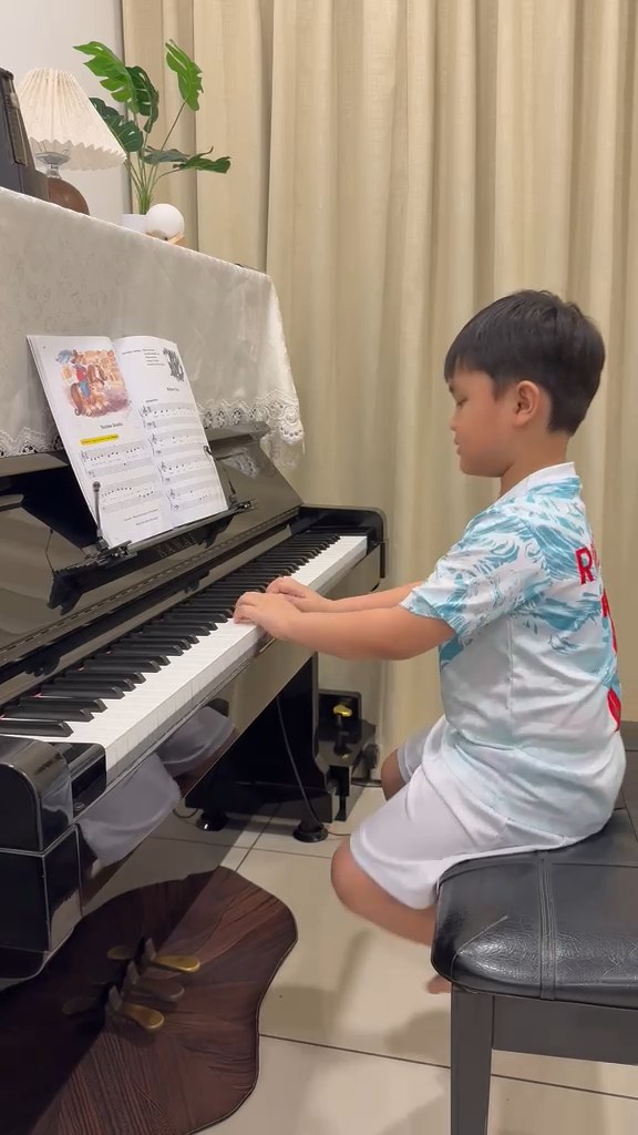 A practice moment at the upright piano.