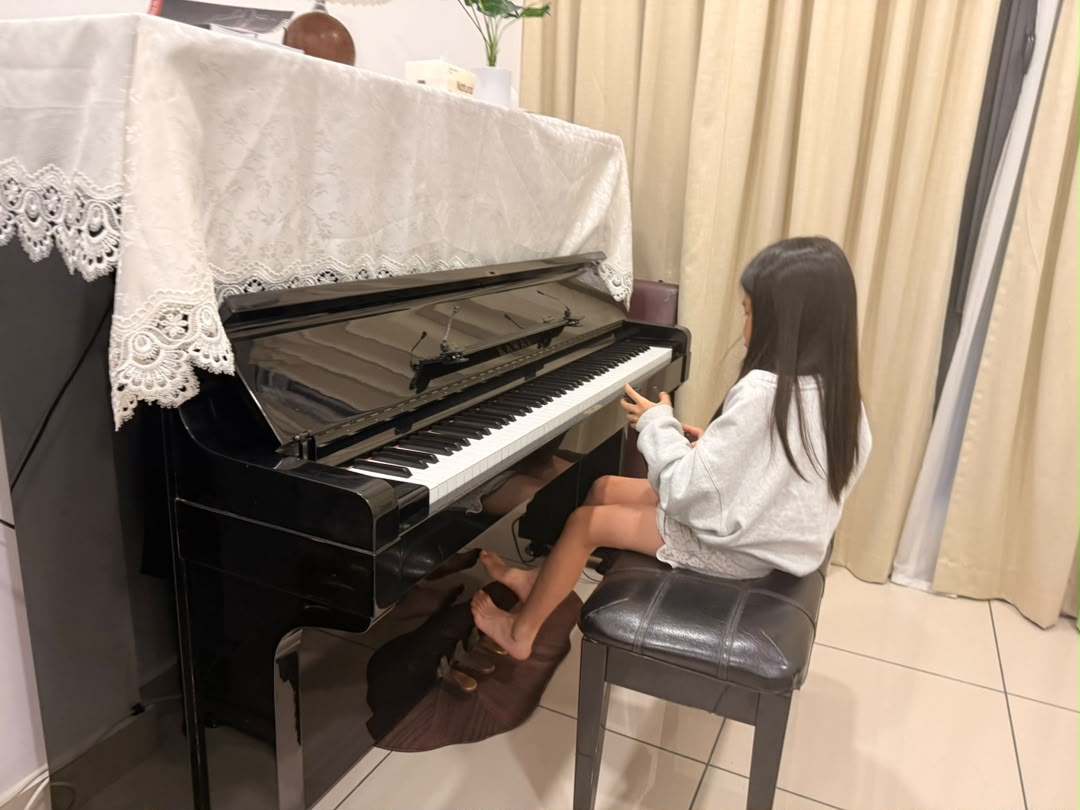 A learner at the piano in the studio